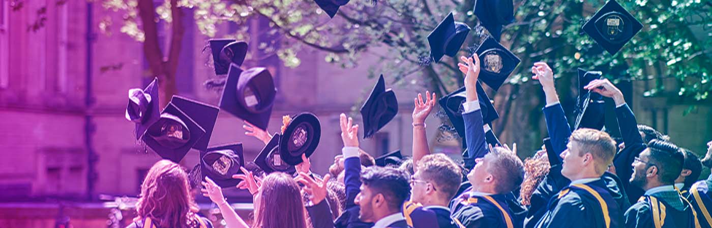 Graduates throwing their mortarboards into the art after graduation